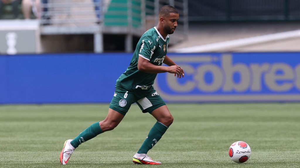 Rafael Navarro of Palmeiras competes for the ball with Claudinho